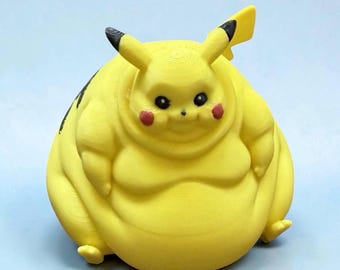 May include: A yellow, round, 3D-printed figurine of a character with long ears tipped in black, small black eyes, and red circular cheeks. The figure has a very wide, stout body shape with visible horizontal layer lines from the printing process.