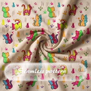 May include: A beige fabric featuring a repeating pattern of colorful, scribbled-style cats in various poses, interspersed with small paw prints, butterflies, and vertical lines. The text "Seamless pattern" is printed in white across the center.