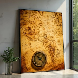 May include: A rectangular wall art piece featuring a vintage-style map of the Americas in shades of sepia and tan. A circular brass-toned compass is mounted on the lower portion of the map, which includes intricate line drawings and text.