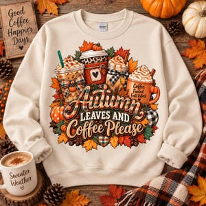 Puede incluir: Una sudadera de cuello redondo color crema con un estampado gráfico de tres tazas de café rodeadas de hojas de otoño y calabazas. El texto dice Autumn Leaves and Coffee Please y Coffee Fueled Fall Vibes.