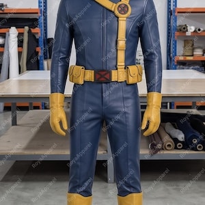 May include: A dark blue long-sleeved jumpsuit with a front zip, paired with yellow gloves and knee-high yellow boots. A yellow utility belt with two pouches and a central red X emblem is worn, along with a matching yellow shoulder strap.