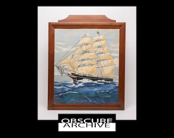 May include: A framed painting of a tall ship sailing on blue waves under a light blue sky. The ship has white sails and a black hull. The frame is made of dark wood. The text "OBSCURE ARCHIVE" is at the bottom.