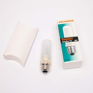 May include: A Sylvania Tungstène Halogène T10 120V light bulb with a white, cylindrical glass tube and a silver base, next to its packaging. The packaging is white with teal and black accents and the Sylvania logo.