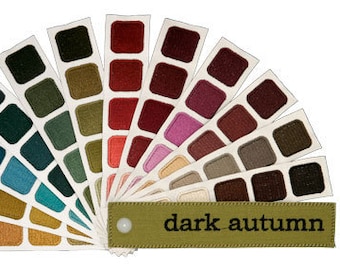 May include: A color palette fan showing a range of colors for the "Dark Autumn" color season. The fan includes shades of brown, green, red, and purple.