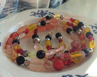 Pretty beaded necklace in blacks,pinks and yellows