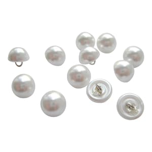 May include: A collection of 12 white pearl-like buttons with a silver shank.