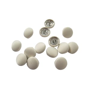 May include: A collection of off-white round buttons with a silver shank. The buttons are scattered on a white background.