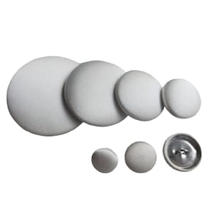 May include: A set of six white fabric covered buttons in various sizes. The buttons are round and have a smooth surface. The largest button is about 2 inches in diameter.