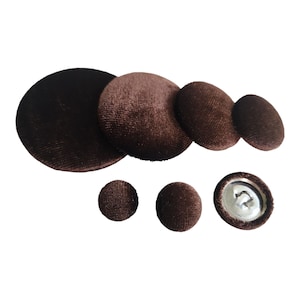 May include: Assortment of brown velvet buttons in various sizes, including a button with a silver shank.