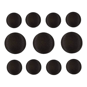 May include: Ten black round buttons of various sizes.