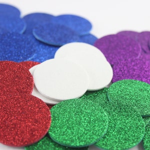 May include: A collection of colorful, glittery, circular confetti in shades of red, blue, green, purple, and white. The confetti is scattered, creating a festive and decorative appearance, suitable for various craft projects and celebrations.