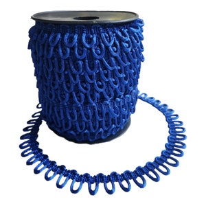 May include: A spool of royal blue trim with a looped design. The trim is made of a soft, flexible material and is perfect for adding a touch of elegance to any project.