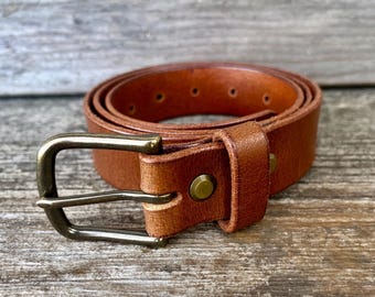 Tan leather belt with solid brass buckle. Polished, antiqued or nickel.