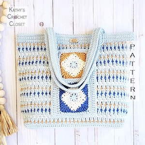 May include: A crocheted tote bag with blue, white, and brown yarn. The bag has two straps and a square design with a geometric pattern.