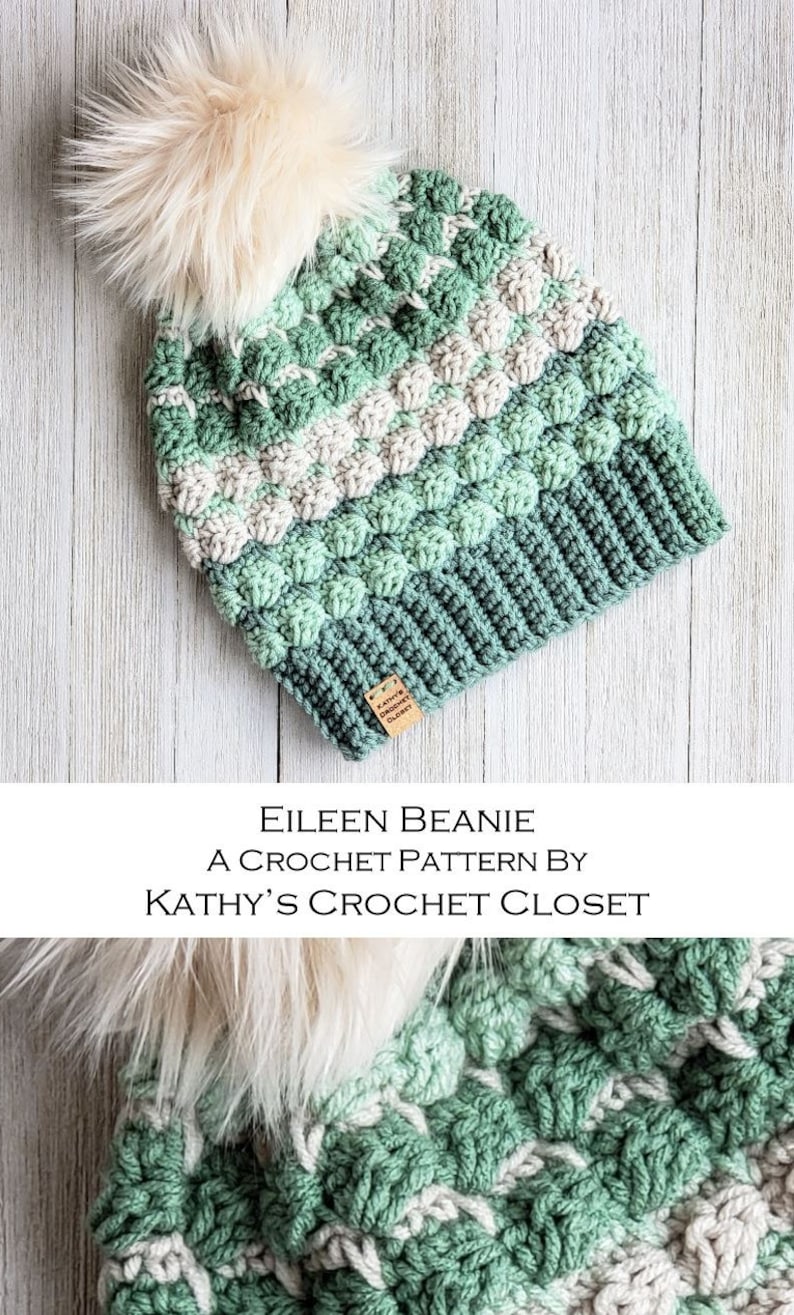 May include: A green and white crochet beanie with a fluffy pom pom. The beanie has a textured stitch pattern and is labelled "Kathy's Crochet Closet".