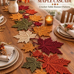 May include: A crochet table runner pattern titled AUTUMN MAPLE CASCADE featuring a series of interconnected maple leaves in shades of red, orange, yellow, and olive green. The runner is displayed on a wooden table with place settings and a candle.