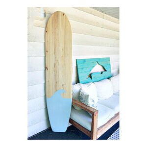 Large 6 foot wood Longboard style surfboard wall art with natural wood and a light blue wave sign decor