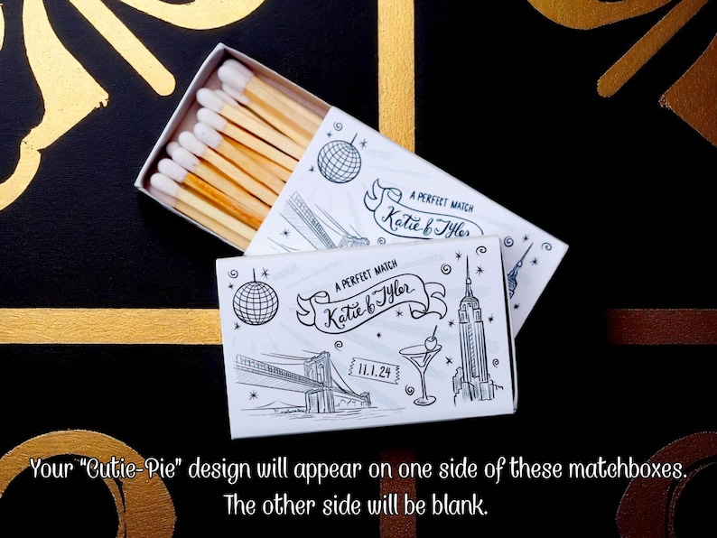 May include: Matchbox with a white box and a black and white illustration of a disco ball, the Brooklyn Bridge, a cocktail, and the Empire State Building. The text reads "A Perfect Match Katie & Tyler" and "11.1.24".