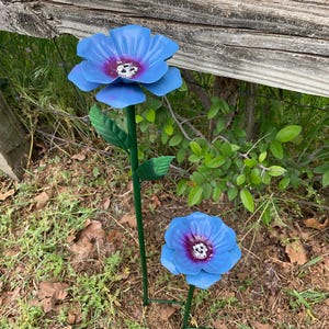 May include: A set of three ceramic mugs with a speckled, matte finish. The mugs are in shades of cream, light gray, and dark gray. Each mug has a simple, modern design and a rounded handle. The mugs are stacked on top of each other.