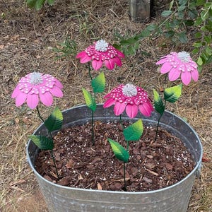May include: A white ceramic mug with a black handle and the text "But First, Coffee" in a bold, black font. The mug is set against a blurred background, suggesting a cozy setting.