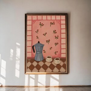 May include: A framed painting depicting a blue moka pot and two white coffee cups on a brown and white chequered surface. The background features a pink wall with a repeating floral pattern and a border of light pink rectangular tiles.