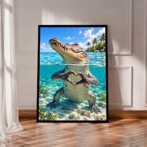 May include: A framed wall art print featuring a split-level view of an alligator in clear turquoise water. The alligator is partially submerged, with its head above the surface and its front claws forming a heart shape underwater.