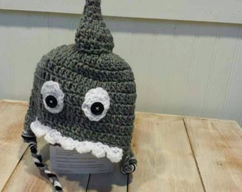 May include: Gray crocheted shark hat with white crocheted teeth and white button eyes. The hat has a long tail with black and white stripes.