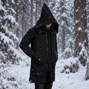 May include: A black long-sleeve jacket featuring a large, pointed hood and a full-length front zipper. The garment has two deep side pockets and a textured surface, extending to mid-thigh length, designed for cold weather conditions.