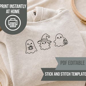 May include: A light heather gray sweatshirt featuring a black line art embroidery design of three ghosts. One ghost holds a pumpkin, one wears a witch hat, and one carries a jack-o'-lantern bucket. Text on the image reads PRINT INSTANTLY AT HOME, PDF EDITABLE, and STICK AND STITCH TEMPLATES.
