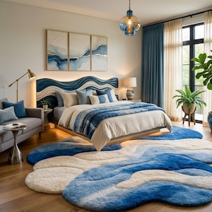 May include: A bedroom featuring a wave-patterned headboard in blue and cream, a bed with blue and white bedding, and a large, irregularly shaped area rug with a blue and cream wave design. A gray sofa, a floor lamp, and a blue glass pendant light.