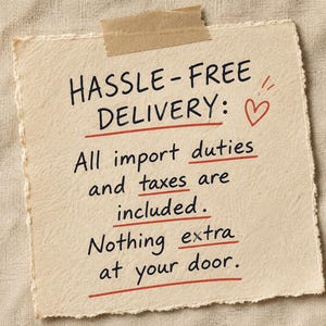 May include: A square piece of off-white textured paper with deckled edges, attached with a strip of tan masking tape. The paper features black handwritten text: HASSLE-FREE DELIVERY: All import duties and taxes are included. Nothing extra at your door.