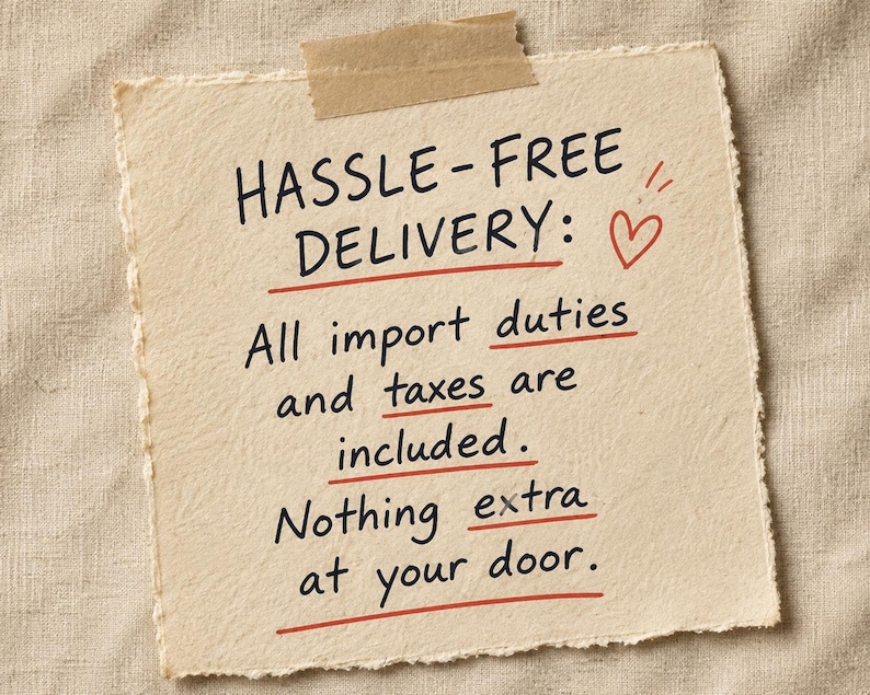 May include: A square piece of off-white textured paper with deckled edges, attached with a strip of tan masking tape. The paper features black handwritten text: HASSLE-FREE DELIVERY: All import duties and taxes are included. Nothing extra at your door.