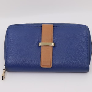 May include: A blue leather wallet with a textured finish. The wallet has a brown leather strap with a gold-colored metal clasp. The wallet has a zipper closure and a gold-colored zipper pull.