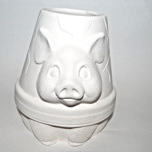 May include: White ceramic piggy bank planter with a textured pig face and a crackled glaze. The planter has a wide opening at the top for planting.