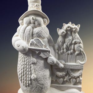 May include: White ceramic snowman figurine playing a violin with three kittens perched on a fence behind him. The snowman is wearing a hat and scarf. The fence is decorated with hearts and stars.