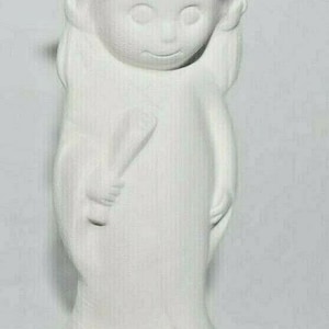 May include: A white ceramic figurine of a person wearing a graduation cap and gown. The figurine has a smiling face and is holding a rolled-up diploma. The base is oval-shaped.