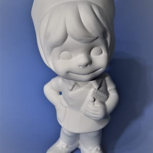 May include: White ceramic figurine of a nurse with a cap and a stethoscope. The figurine is standing with one hand on her hip and the other holding a stethoscope.