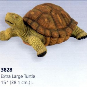 May include: An extra large turtle figurine, 15 inches (38.1 cm) long, with a detailed, textured shell in shades of brown and a yellow-green body. The turtle's head and legs are extended, giving it a lifelike appearance. The figurine is a decorative item.