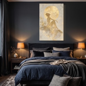 Könnte beinhalten: Ein vertikaler Wandkunstdruck mit der goldenen Silhouette einer Figur, die auf einer wolkenartigen Formation vor einem großen, leuchtenden Goldmond sitzt. Das Kunstwerk verwendet eine Palette aus Metallic-Gold, sanftem Creme und Grautönen für eine himmlische Szene.