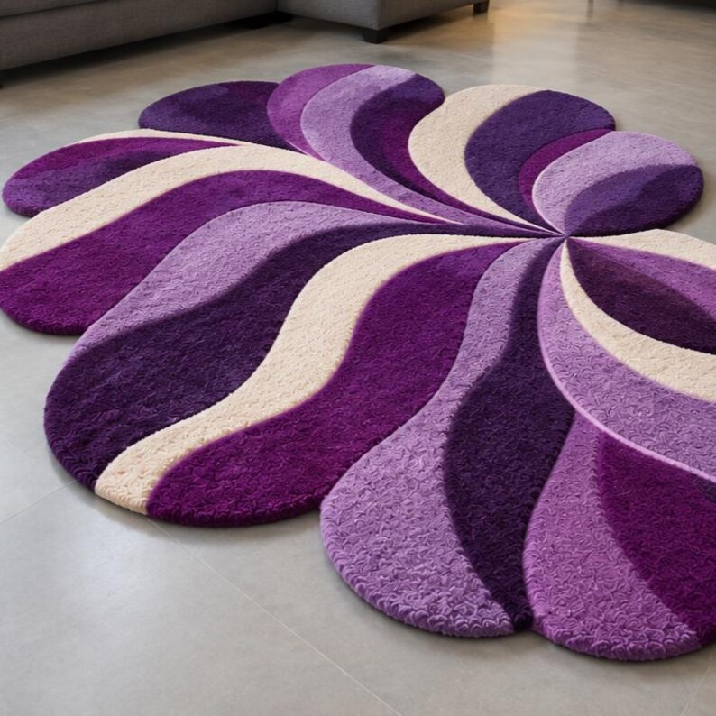May include: A large, irregularly shaped area rug featuring a swirling, floral-inspired pattern. The design consists of alternating curved segments in deep purple, vibrant violet, and soft cream, creating a textured, layered appearance.