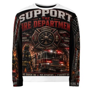May include: A long-sleeve sweatshirt featuring a graphic print of a firefighter standing near a fire truck. The design includes the text SUPPORT THE FIRE DEPARTMENT, COURAGE, HONOR, SACRIFICE, and WE RUSH IN SO OTHERS CAN GET OUT, with a flag motif.
