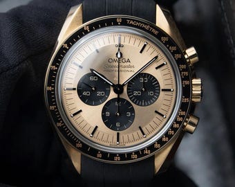 Omega Speedmaster UNWORN 5/2026 Moonwatch Pikachu Yellow Gold Chronograph 42mm 310.62.42.50.99.001