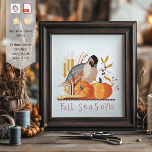 May include: A framed cross-stitch pattern featuring a bird perched next to orange pumpkins and wheat stalks, with the text "Fall Seasons" below. The design uses 14 DMC colors and measures 99 by 93 stitches, utilizing cross stitch and back stitch.