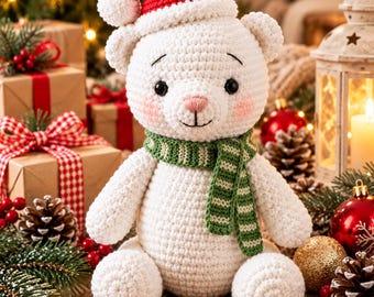 May include: A white crocheted teddy bear featuring a red Santa hat with a white pom-pom, a green and white striped scarf, black button eyes, and pink blush on its cheeks. The bear is seated in a front-facing position with its arms at its sides.