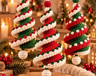 May include: Three spiral-shaped crochet ornaments hanging from a branch. Two ornaments feature green bodies with white spiral accents and red dots, while the center ornament has a red body with white spiral accents and green dots. Each has a hanging loop.