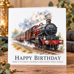 May include: A square greeting card featuring a watercolour illustration of a red and black steam locomotive train numbered 7029 travelling on tracks. The text reads HAPPY BIRTHDAY and HERE'S TO GREAT JOURNEYS AND GOOD TIMES AHEAD in dark blue and brown.