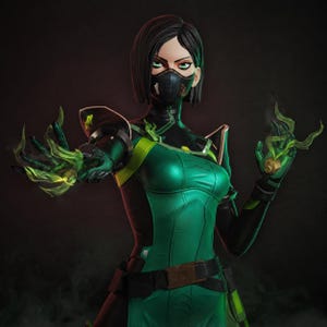 May include: A stylized figurine of a character with short dark hair, wearing a black face mask and a green and black tactical suit. The character has both hands extended forward, with translucent green energy effects emanating from the palms.