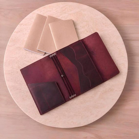 A trifold leather journal with pockets and a refillable design — the kind of handcrafted everyday carry that gets better with age and use.