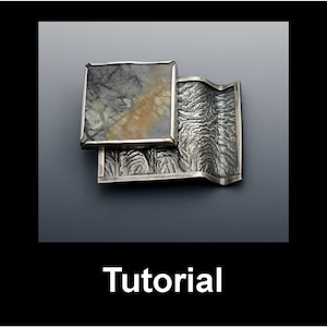 May include: A silver-toned brooch with a rectangular stone and a textured, wave-like design. The stone has a gray and tan pattern. The word "Tutorial" is written in white at the bottom of the image.