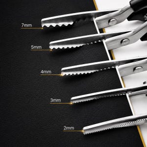 May include: A set of five metal pinking shears with black handles, each featuring a different serrated blade edge. The blades are labeled with specific tooth sizes of 7mm, 5mm, 4mm, 3mm, and 2mm, indicating the width of the zigzag cut produced.